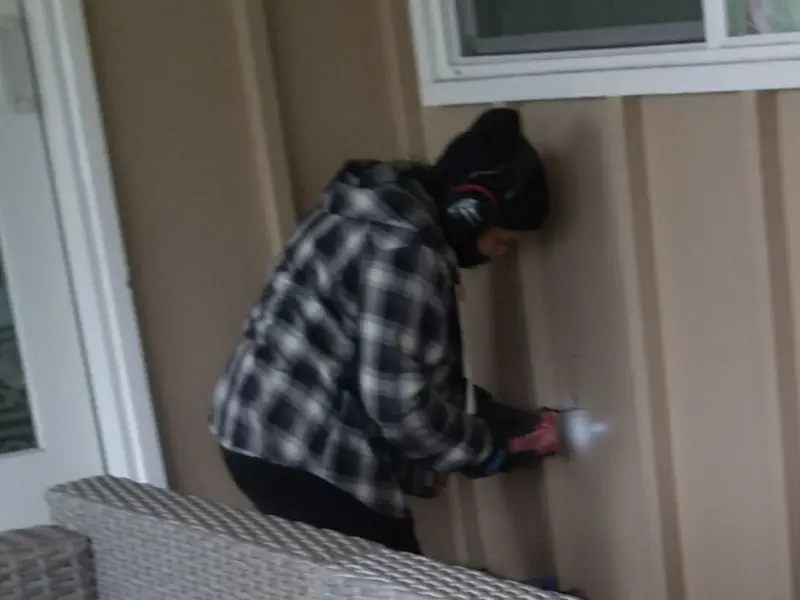 Professional electrician installing an exterior outlet in Brandon